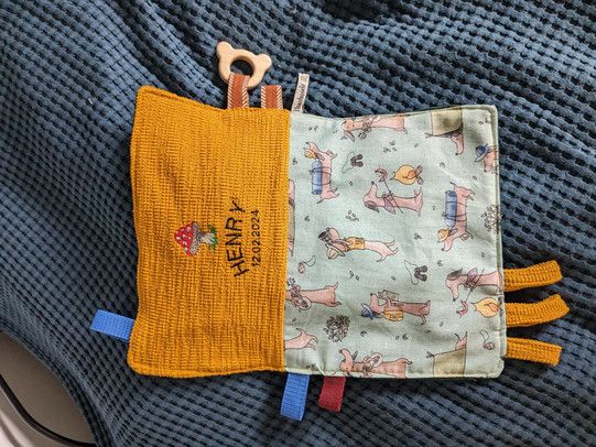 Photo of a self-sewn and embroidered toddler crackle scarf