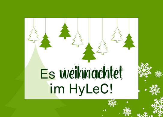 Grafik weißes Feld mit grünem Rand, verziert mit Schneeflocken und Weihnachtsbäumen, alles im TU-Grün. Text "Es weihnachtet im Hylec"